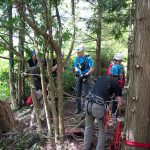 The two rescuers prepare to descend the cliff.