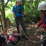 A rescuer manages the rope in the tailer position.