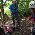 A rescuer manages the rope in the tailer position.